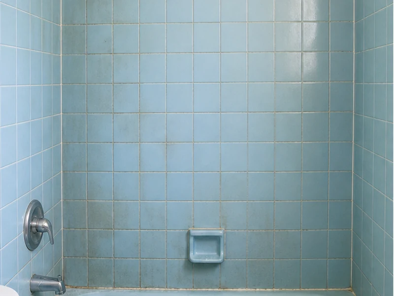 Dated powder-blue tile shower surround with gray grout in a Niles home before reglazing, Fremont